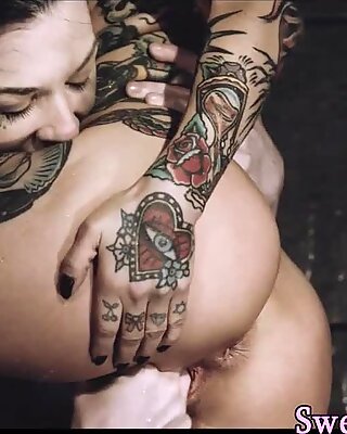 Tattooed milf lesbian gets fingered